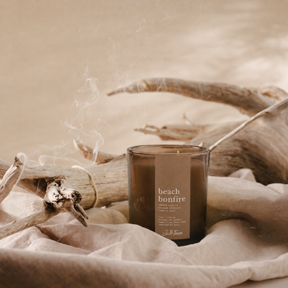 A smoky amber glass candle jar labeled &
